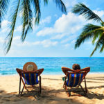 Couple relax on the beach enjoy beautiful sea on the tropical island. Summer beach vacation concept